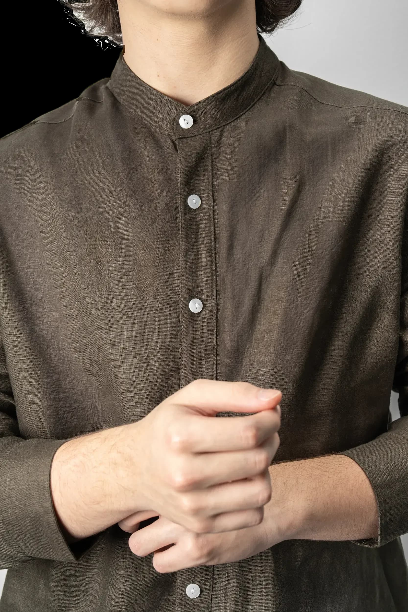 Olive shirt buttons, close on model