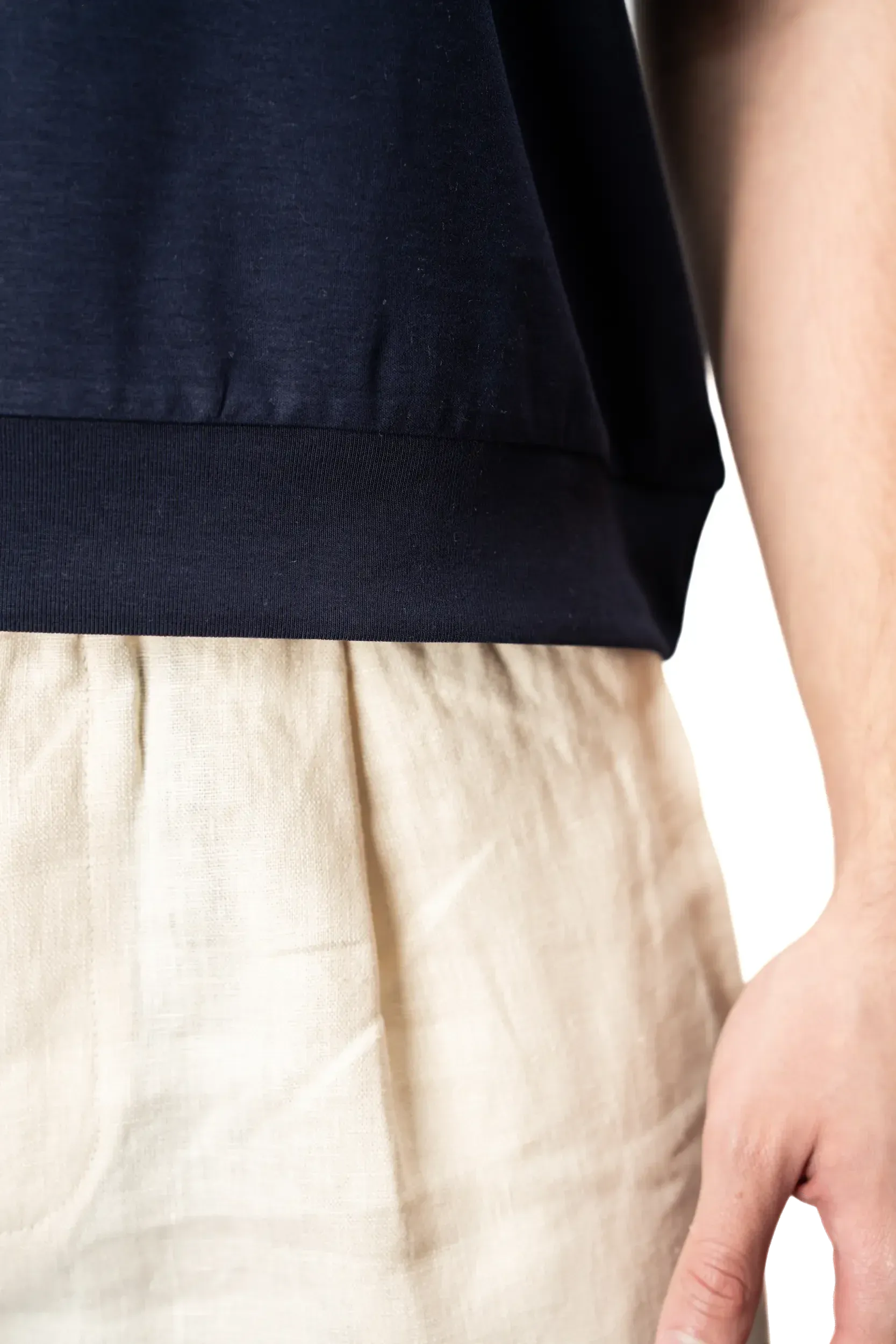 Beige trousers waist detail with polo hem